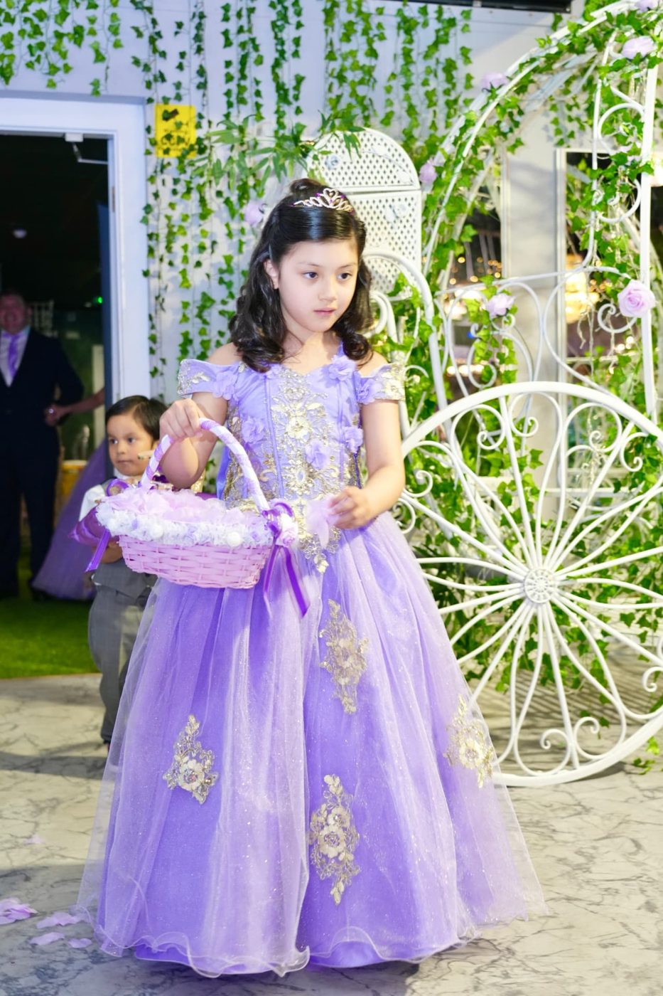 A young flower girl in a lilac gown at a YUDYUD Events celebration in London