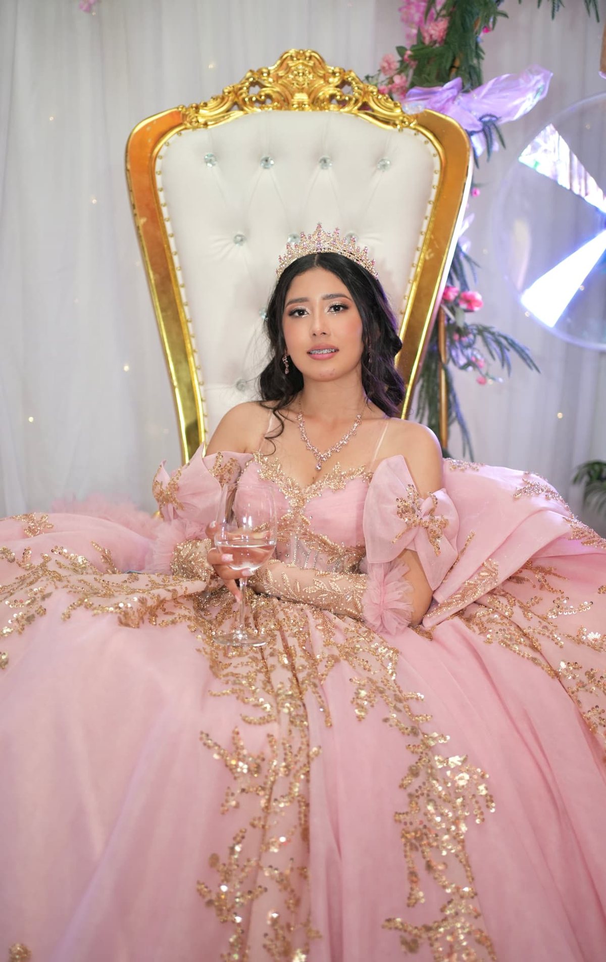Quinceanera celebrant on a gold throne chair in a pink couture gown, styled by YUDYUD Events